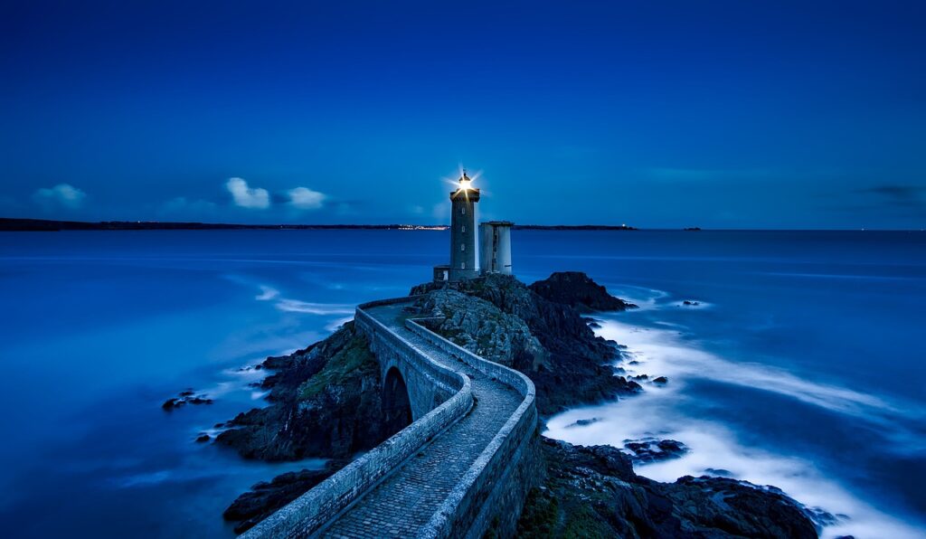 A lighthouse shining brightly in the night, symbolizing the guidance and direction the Reboot Roadmap provides in navigating the potential pitfalls of change management